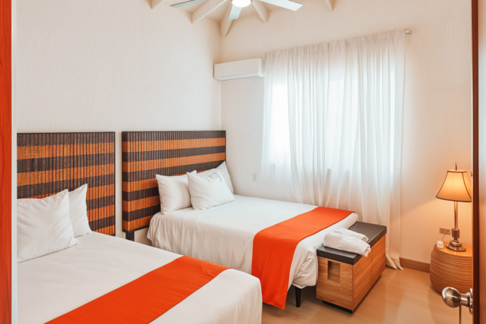 Visible twin beds inside of a room of EKolojik Resort in cap-haitien